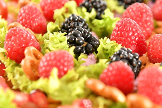 A fruit salad with berries and walnuts