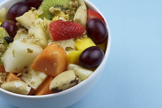 Fruit salad with chestnuts and granola in a bowl