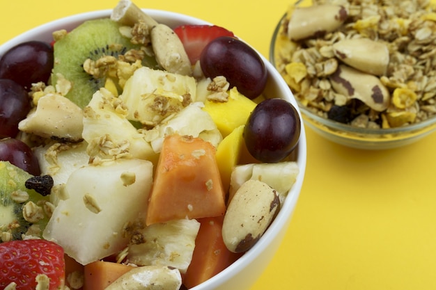 Fruit salad with chestnuts and granola in a bowl