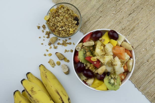 Fruit salad with chestnuts and granola in a bowl