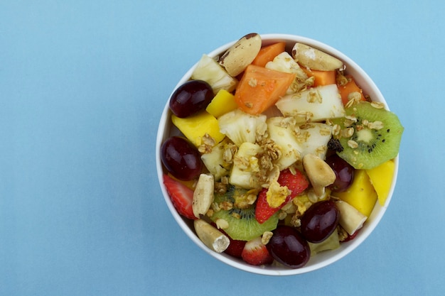 Fruit salad with chestnuts and granola in a bowl