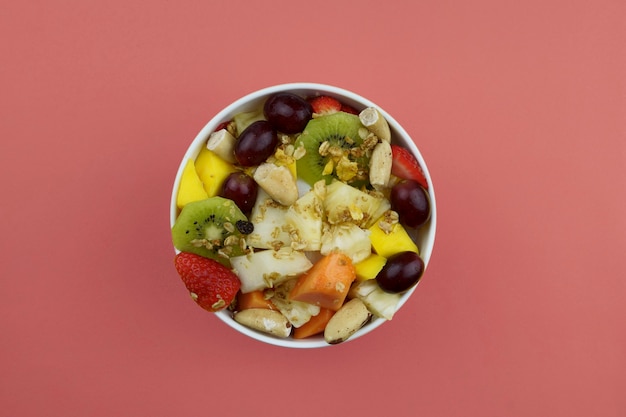 Fruit salad with chestnuts and granola in a bowl