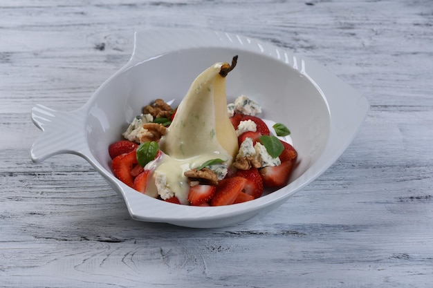 Fruit salad with strawberries, pears and Roquefort cheese