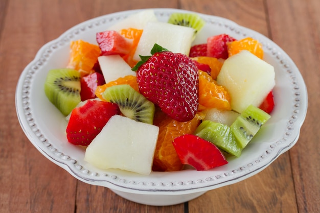 Fruit salad with strawberry on the plate