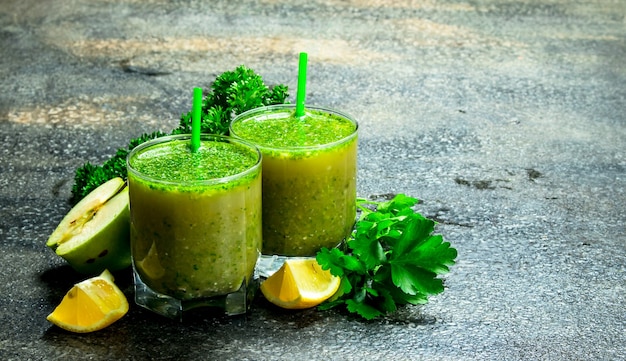 Fruit smoothie in glasses. On rustic background.