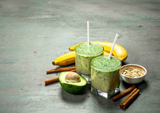 Fruit smoothie in glasses on rustic table.