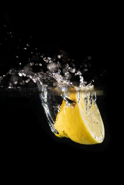 Photo fruit splash in studio with black background