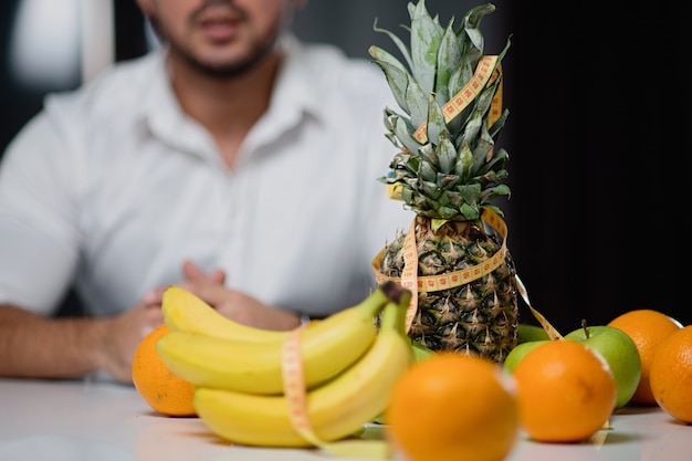 Fruit on the table closeup with a man