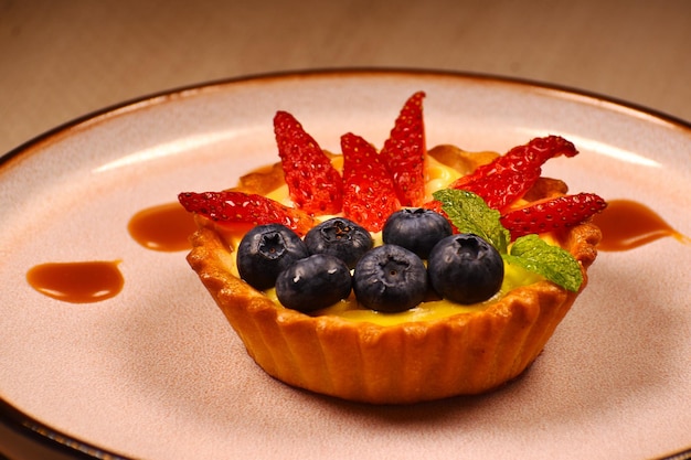 A fruit tart with blueberries on top