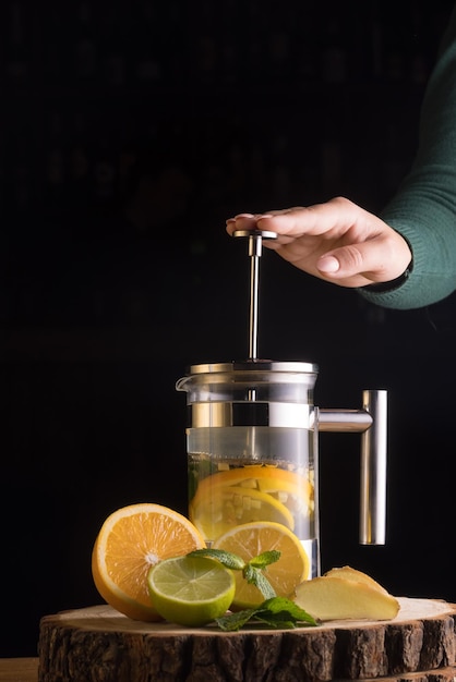 Fruit tea with lemon and orange mint on a dark background