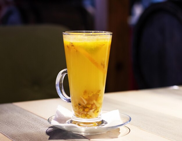 Fruit tea with strawberries on a wooden table