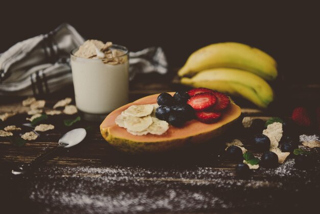 Fruitbased breakfast on dark wooden table