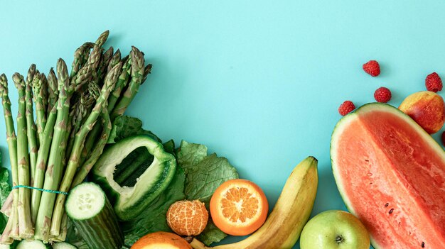 Fruits berries and vegetables on a blue background