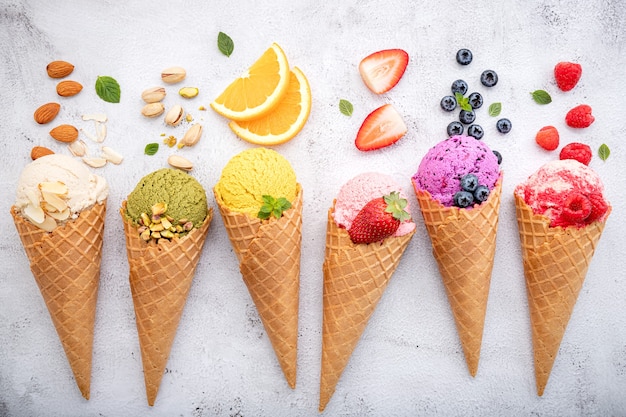 fruits in cones setup on white stone background .