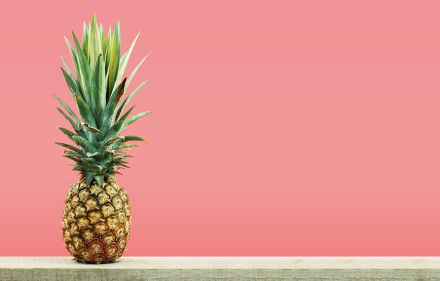 Fruits growing on table against orange background