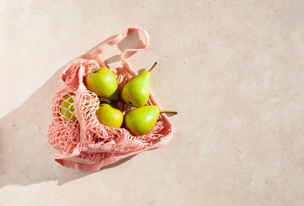 Fruits pears in reusable mesh cotton bag, plastic free zero waste concept