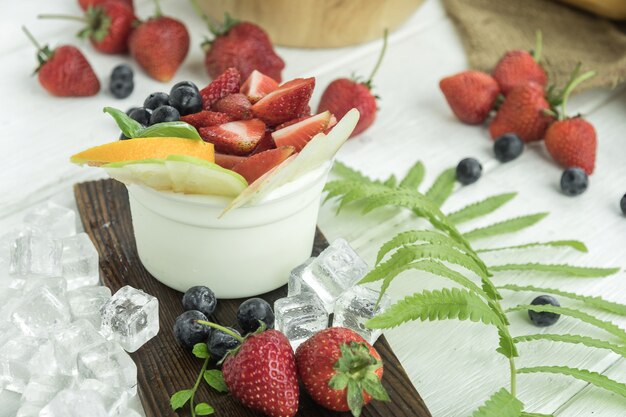 The fruits salad yogurt in glass bowl