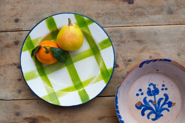 fruits tangerine and pear in vintage porcelain dish plate