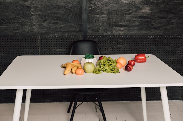 Photo fruits and vegetables are laid out on a white table