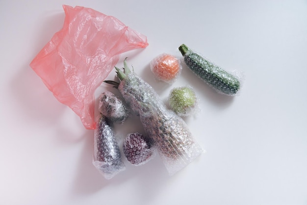 fruits and vegetables packaged in plastic wrap