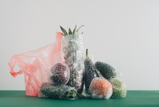 fruits and vegetables packaged in plastic wrap