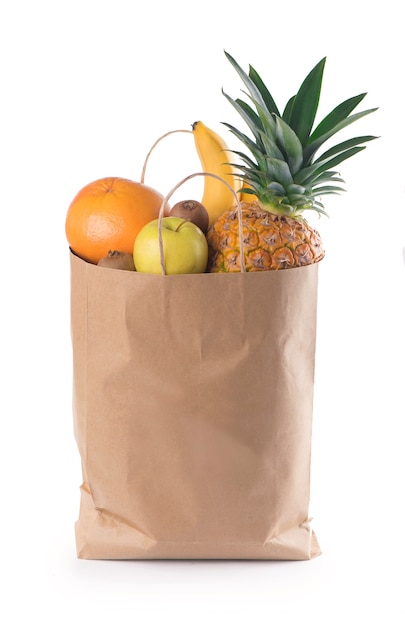 Fruits and vegetables in paper grocery bag isolated over white background