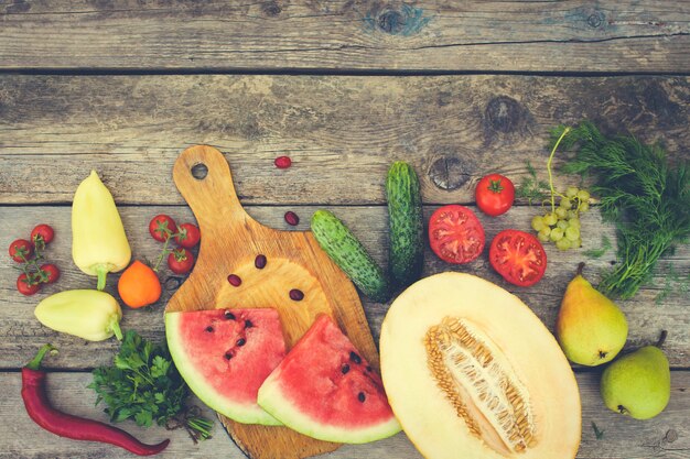     Fruits, vegetables on wooden . Toned image. 