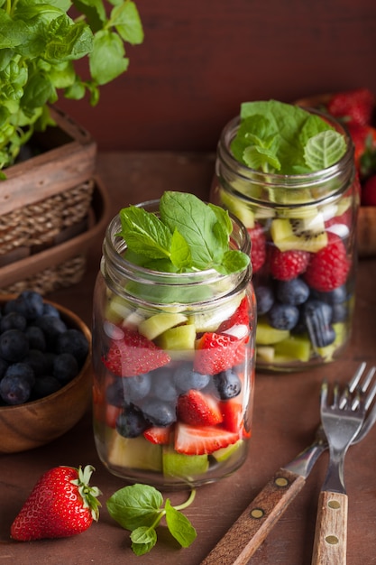 Fruitsalade in mason jar aardbei bosbessen kiwi appel munt