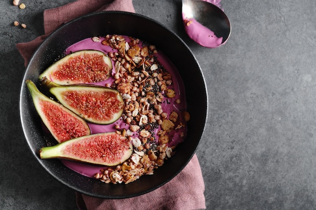 Fruity bowl with muesli granola and figs served in bowl