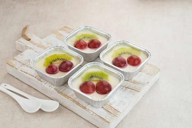 Fruity Milk Pudding, sweet vanilla silk pudding dessert with grape and kiwi fruit topping