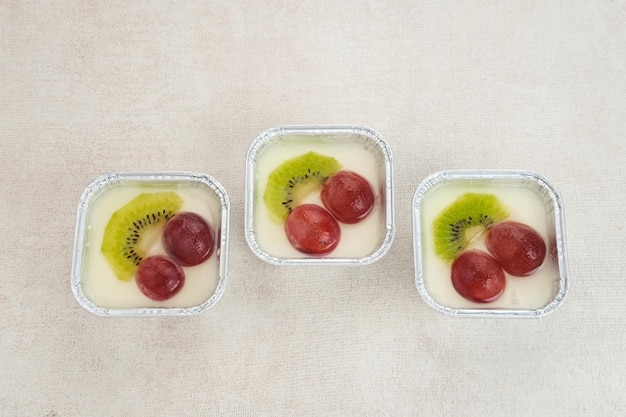 Fruity Milk Pudding, sweet vanilla silk pudding dessert with grape and kiwi fruit topping