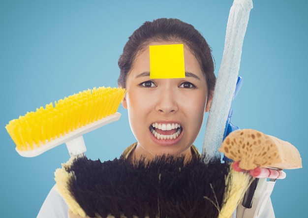 Frustrate woman with sticky notes stick on forehead holding cleaning equipment