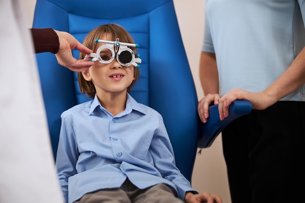 Frustrated boy cannot see the letters on a chart