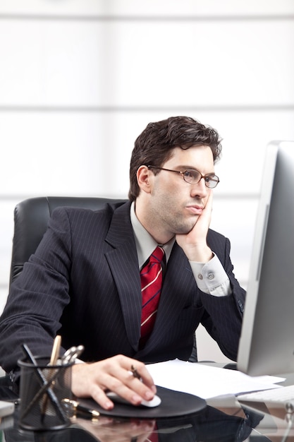 Frustrated businessman in front of the computer.