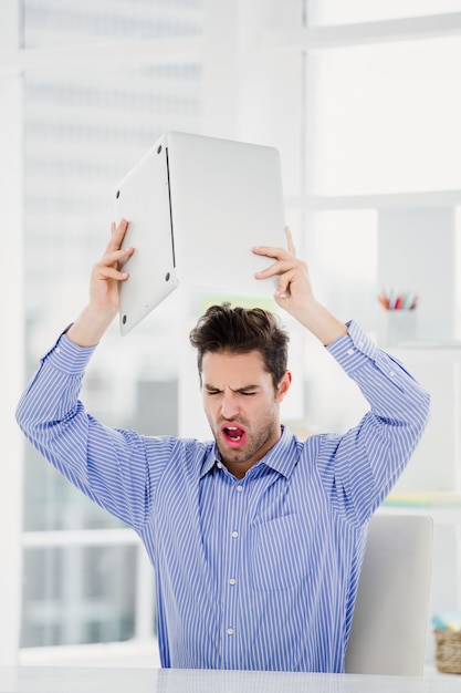 Photo frustrated businessman throwing laptop