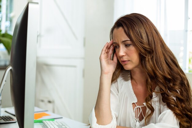 Frustrated businesswoman relaxing at desk