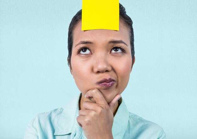 Frustrated businesswoman with sticky note stuck on her forehead