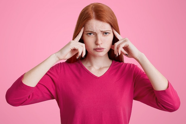 Frustrated female with freckled skin