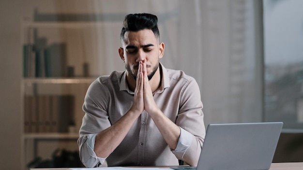 Frustrated hispanic young guy business man in office sadness accountant stressed about bank loan