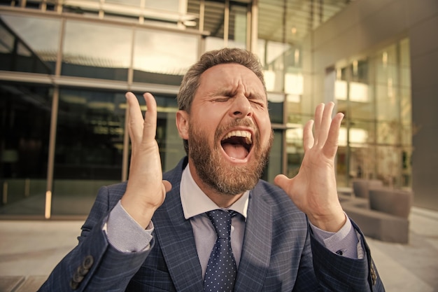 Frustrated man in businesslike suit manager executive express emotions