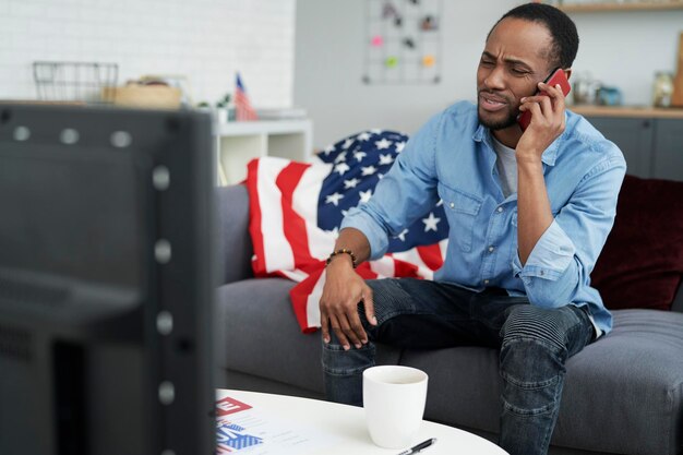 Frustrated man having a phone conversation