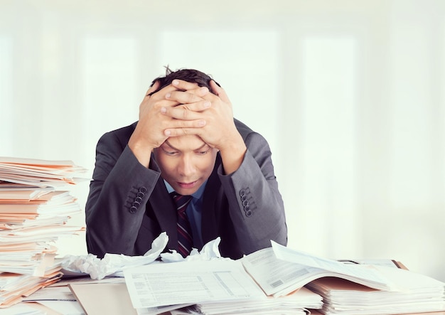 Frustrated office manager overloaded with work.