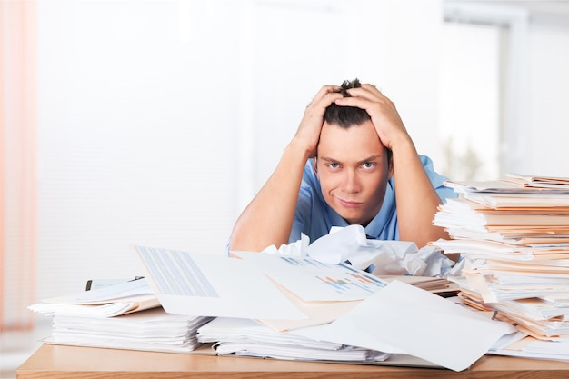 Frustrated office manager overloaded with work.