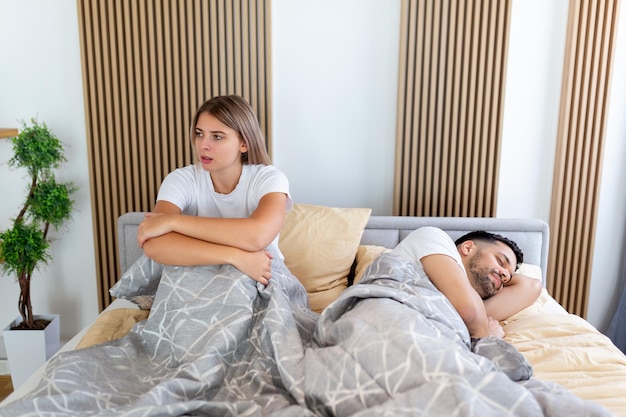 Frustrated sad girlfriend sit on bed think of relationship\
problems thoughtful couple after quarrel lost in thoughts upset\
lovers consider break up offended person disappointed by\
boyfriend