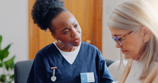 frustrated sad woman speaking or nurse with results in consultation for bad news or cancer stress lady talking or caregiver with a depressed mature patient for empathy sympathy or help in home