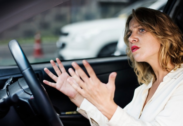 Frustrated woman stuck in traffic