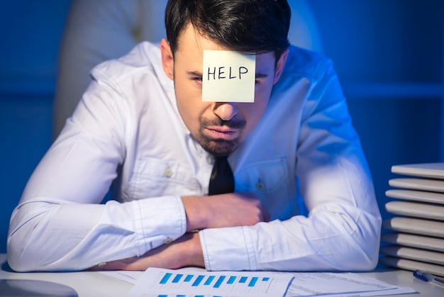 Frustrated young businessman in his office.