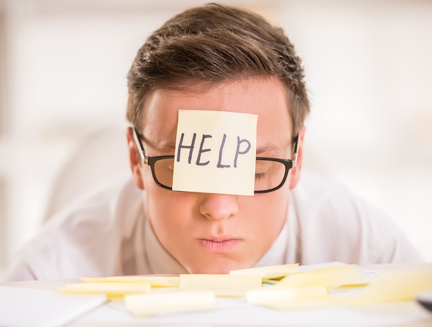 Frustrated young businessman in his office.