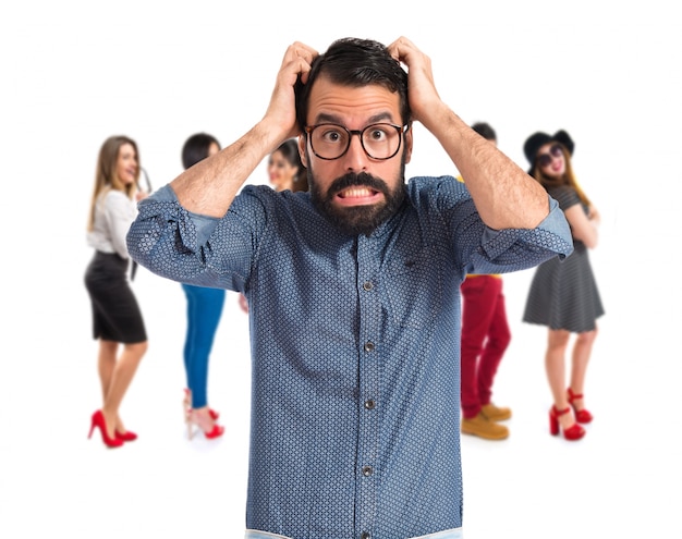 frustrated young hipster man over white background 