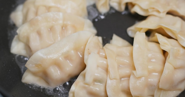 Fry Chinese meat dumpling in skillet pan